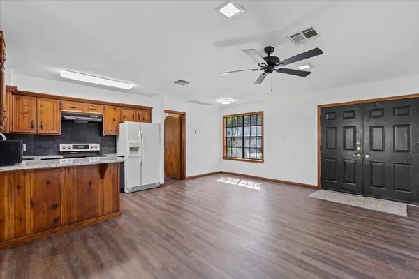 a kitchen with stainless steel appliances granite countertop a stove a sink dishwasher and a refrigerator