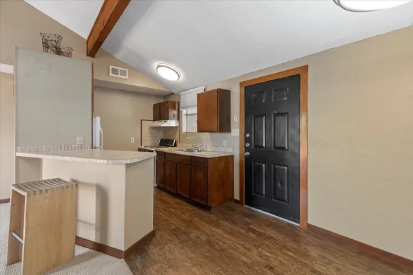 a kitchen with stainless steel appliances granite countertop a sink stove and refrigerator