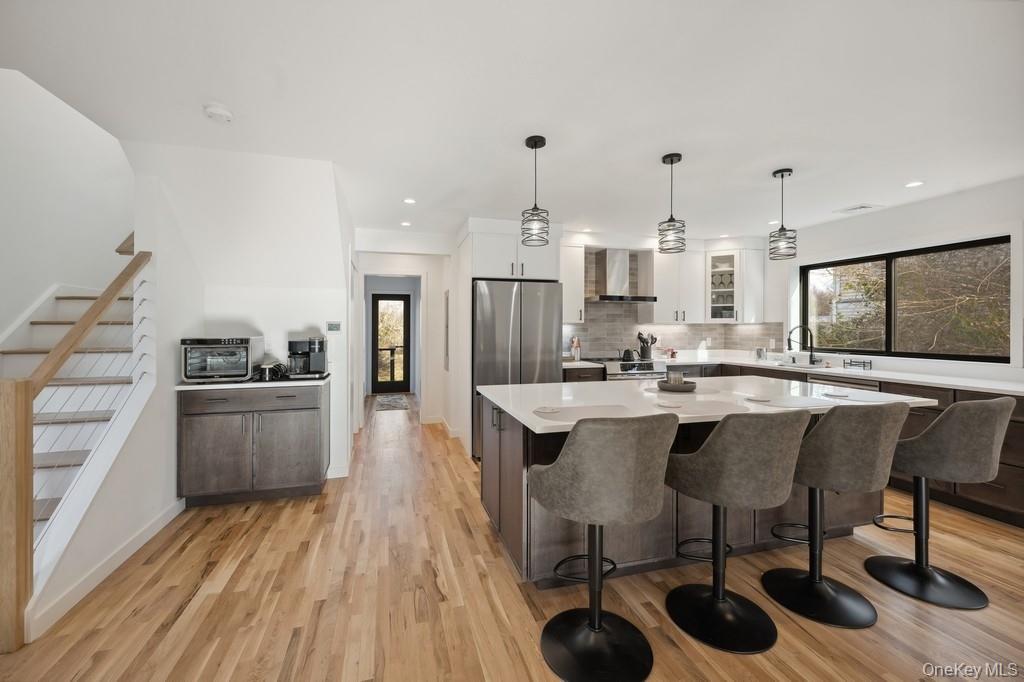 45 Ditch Plains Road Montauk, NY 11954 - Photo 8 of 19 a kitchen with stainless steel appliances granite countertop a sink stove and wooden floor