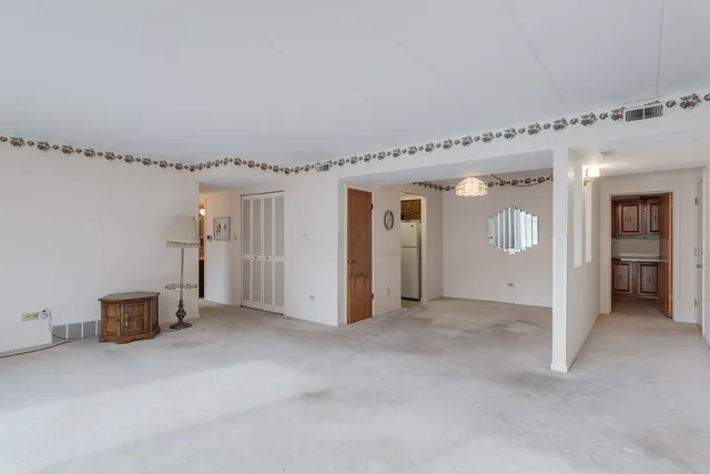 a view of a hallway with wooden shelves