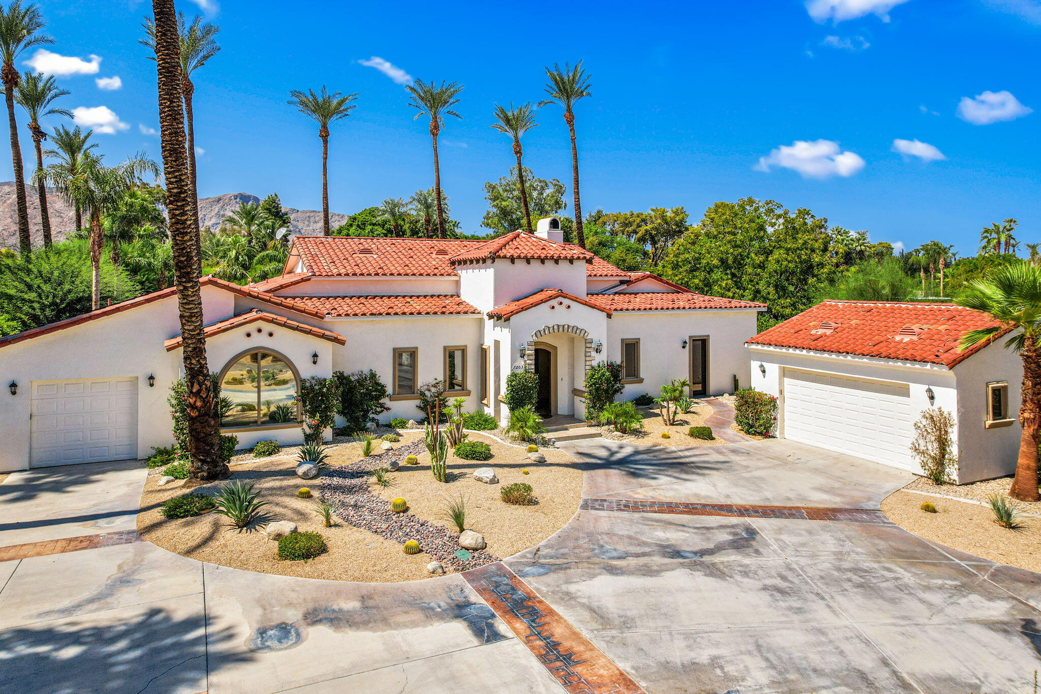 72033 Clancy Lane Rancho Mirage, CA 92270 - Photo 18 of 83 a view of a white house with a swimming pool and sitting area
