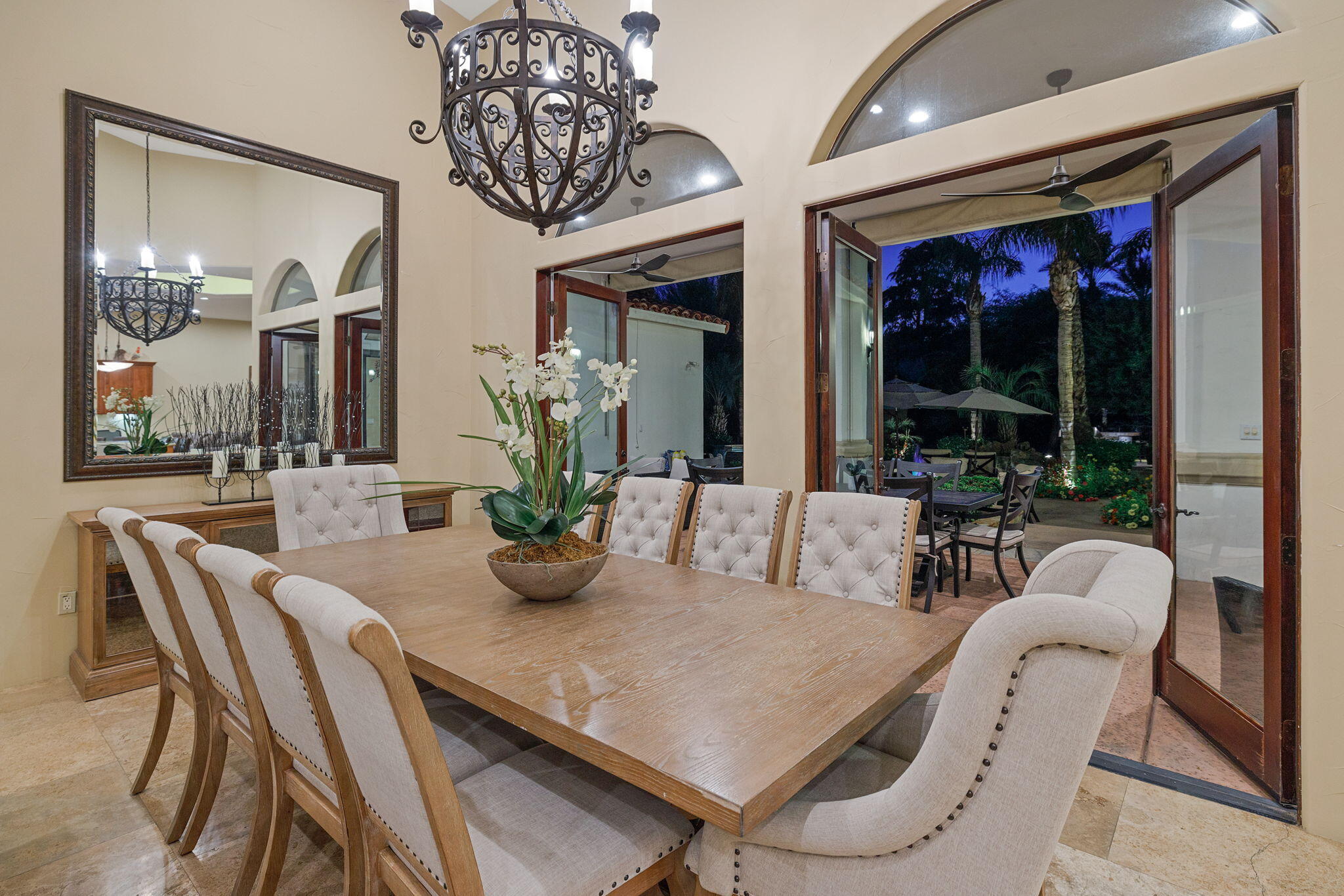 72033 Clancy Lane Rancho Mirage, CA 92270 - Photo 29 of 83 a view of a dining room with furniture large windows and a chandelier
