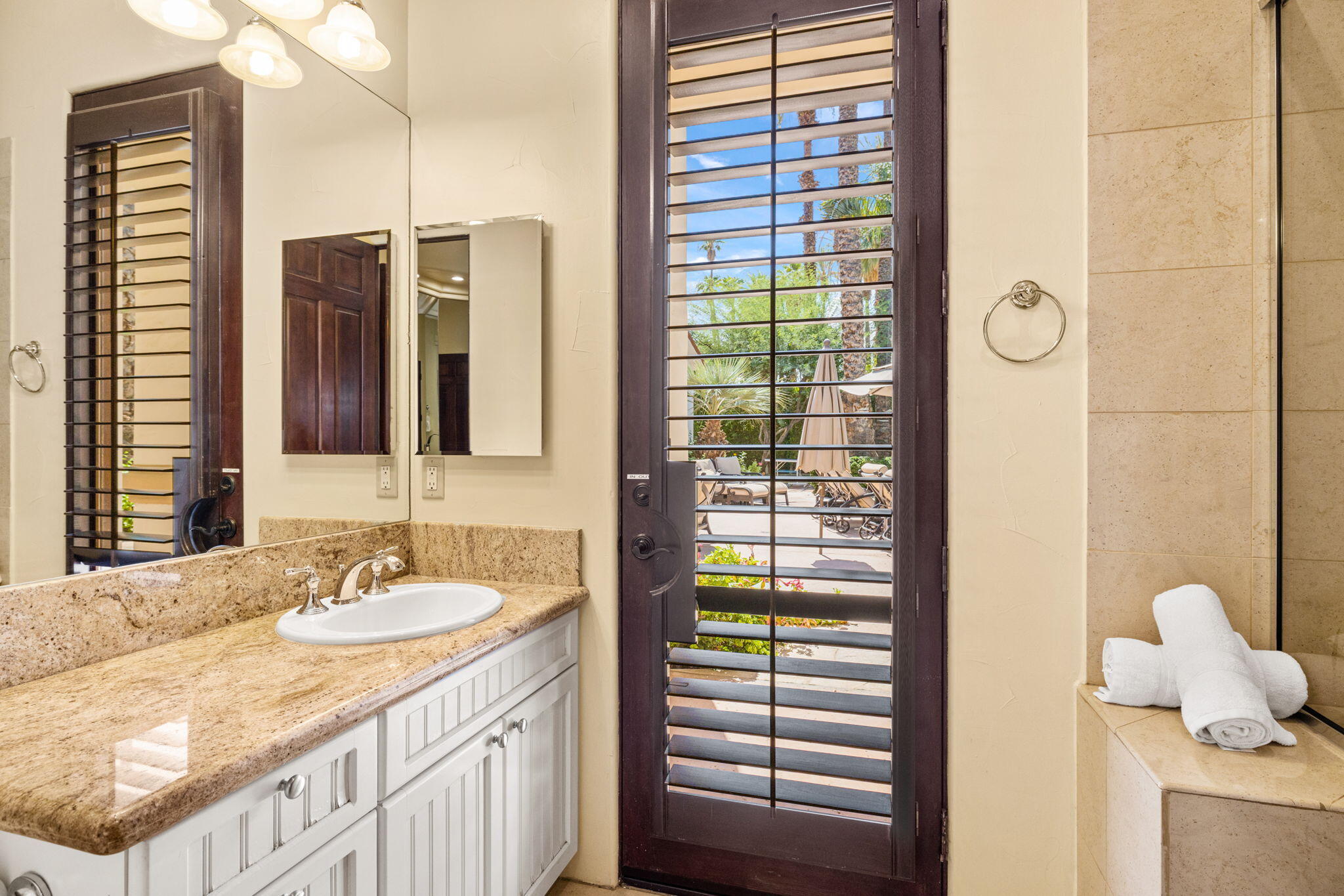 72033 Clancy Lane Rancho Mirage, CA 92270 - Photo 57 of 83 a bathroom with a granite countertop sink and a mirror