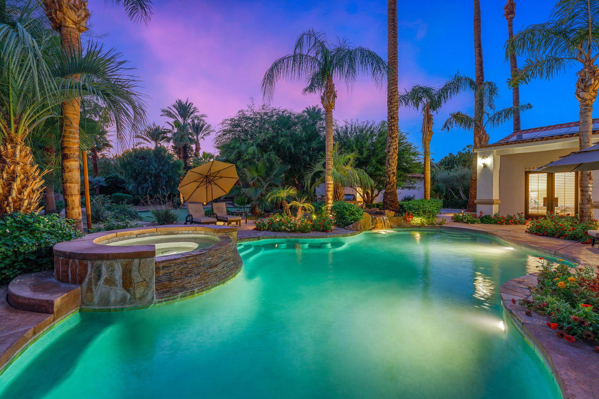 72033 Clancy Lane Rancho Mirage, CA 92270 - Photo 6 of 83 a view of a swimming pool with a table and chairs