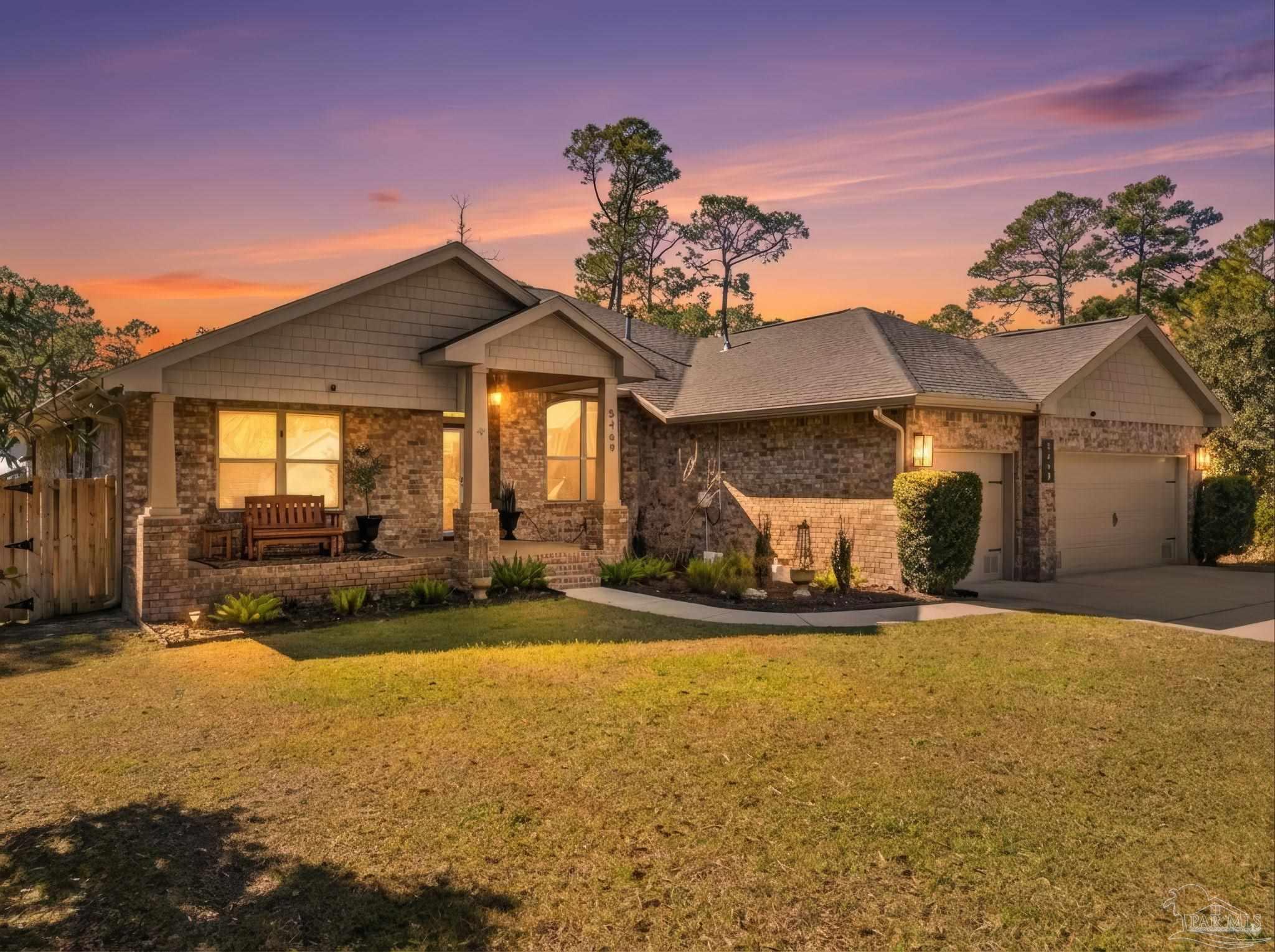 a view of a house with backyard and sitting area