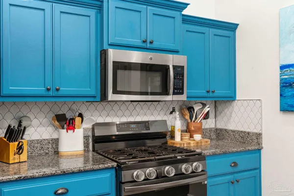 a kitchen with granite countertop cabinets sink and utility