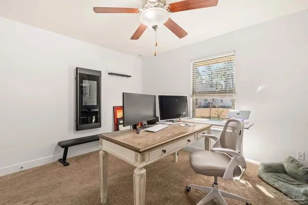 a bedroom with a bed and a flat tv screen on dresser