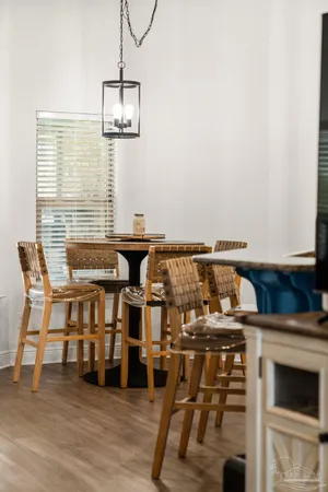 a kitchen with stainless steel appliances granite countertop a stove a sink dishwasher and a refrigerator with wooden floor