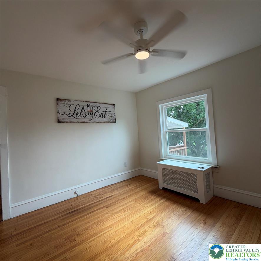 5111 Vera Cruz Road Emmaus, PA 18049 - Photo 16 of 44 Rich hardwood floors and classic crown molding frame a bright window overlooking the yard.