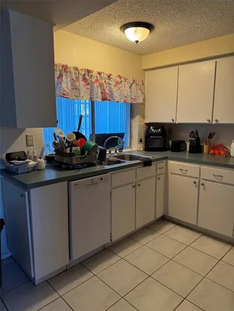 a kitchen with a sink a stove and cabinets