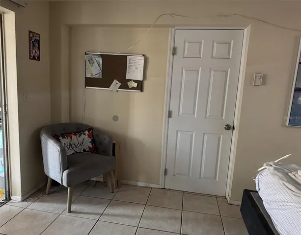 a living room with furniture and a baby crib