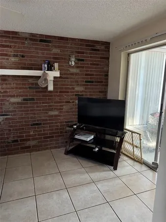 a bedroom with a bed and a television