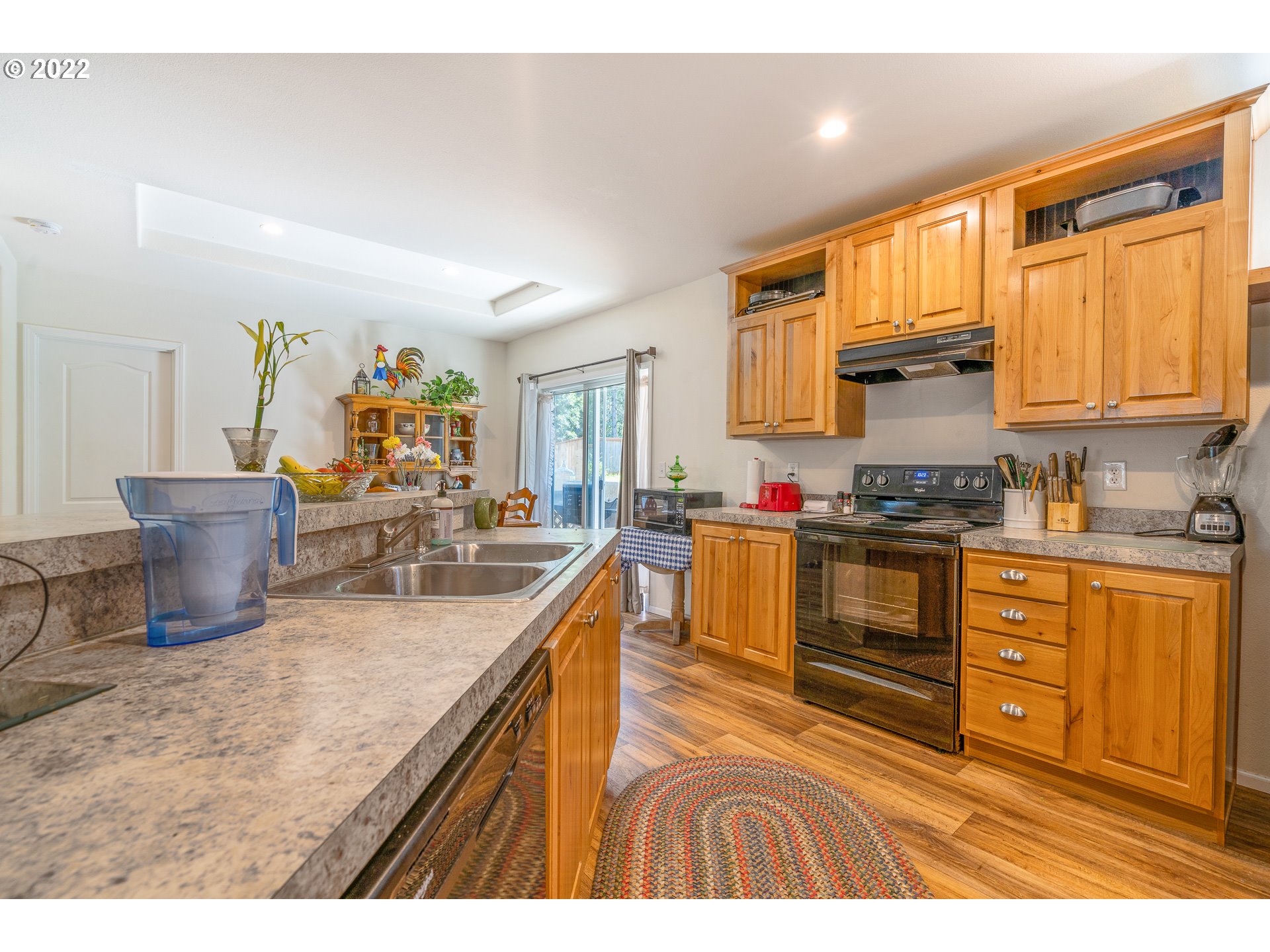 37220 Tree Farm Road Springfield, OR 97478 - Photo 6 of 32 a kitchen with granite countertop a sink stove and cabinets
