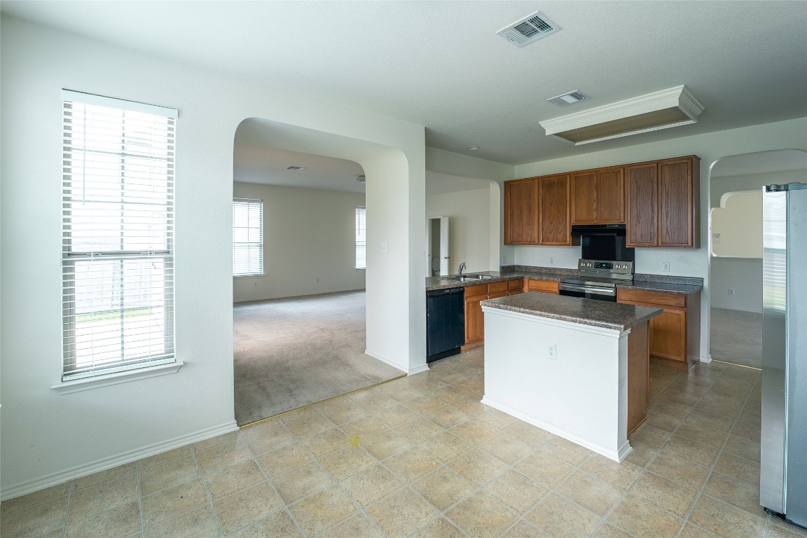 612 Dark Tree Lane Round Rock, TX 78664 - Photo 40 of 40 a kitchen with granite countertop a stove top oven and sink