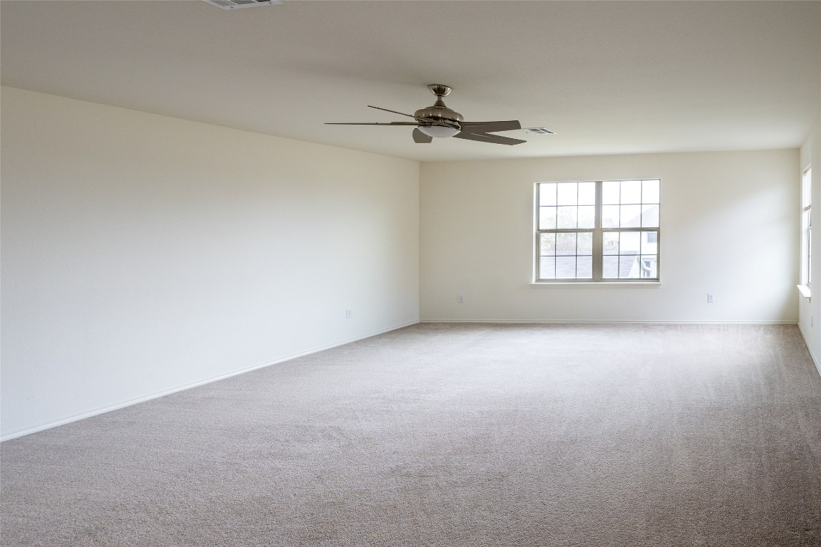 612 Dark Tree Lane Round Rock, TX 78664 - Photo 18 of 40 an empty room with windows and fan