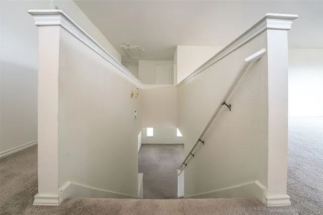 an empty room with a window and a ceiling fan