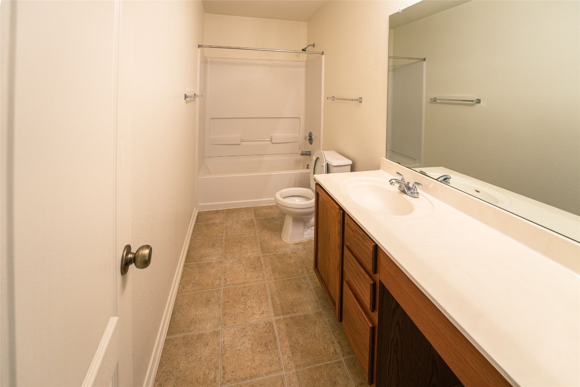 612 Dark Tree Lane Round Rock, TX 78664 - Photo 26 of 40 a bathroom with a sink a toilet and shower