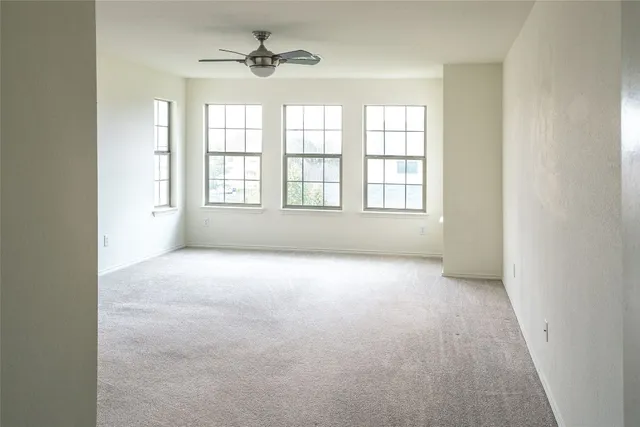 an empty room with a empty space and windows