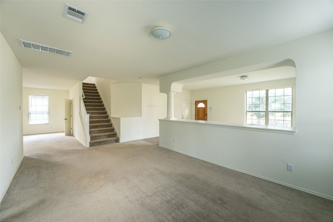 612 Dark Tree Lane Round Rock, TX 78664 - Photo 8 of 40 a view of an empty room with wooden floor and stairs