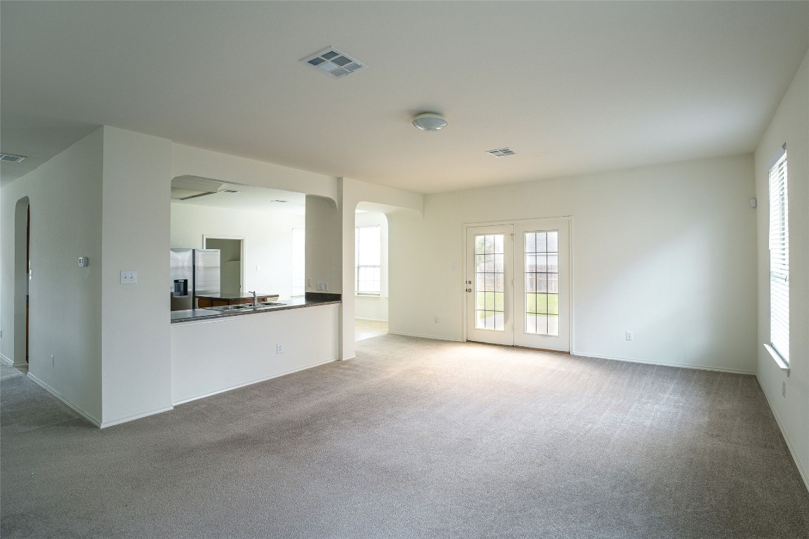 612 Dark Tree Lane Round Rock, TX 78664 - Photo 9 of 40 a view of a big room with windows and chandelier