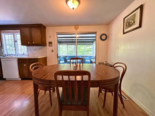 a dining room with furniture and window