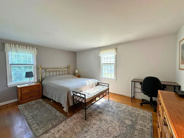 a spacious bedroom with a bed and a window