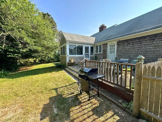 a balcony with wooden floor and outdoor seating