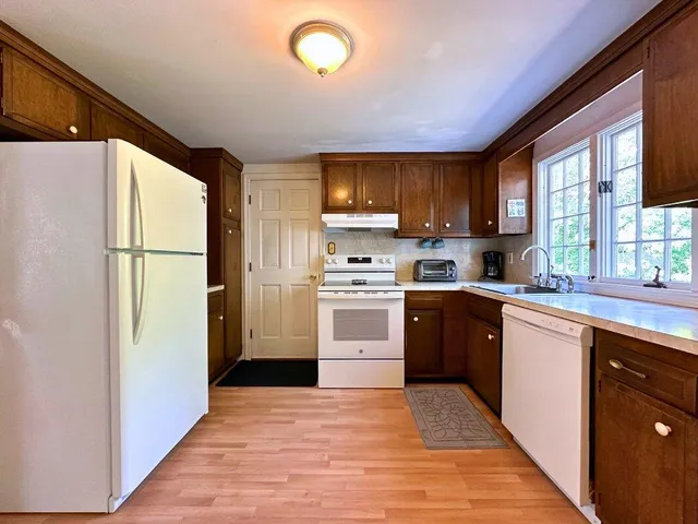a kitchen with a refrigerator stove and sink