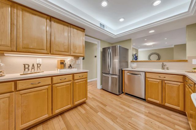a view of a kitchen with wooden floor and windows
