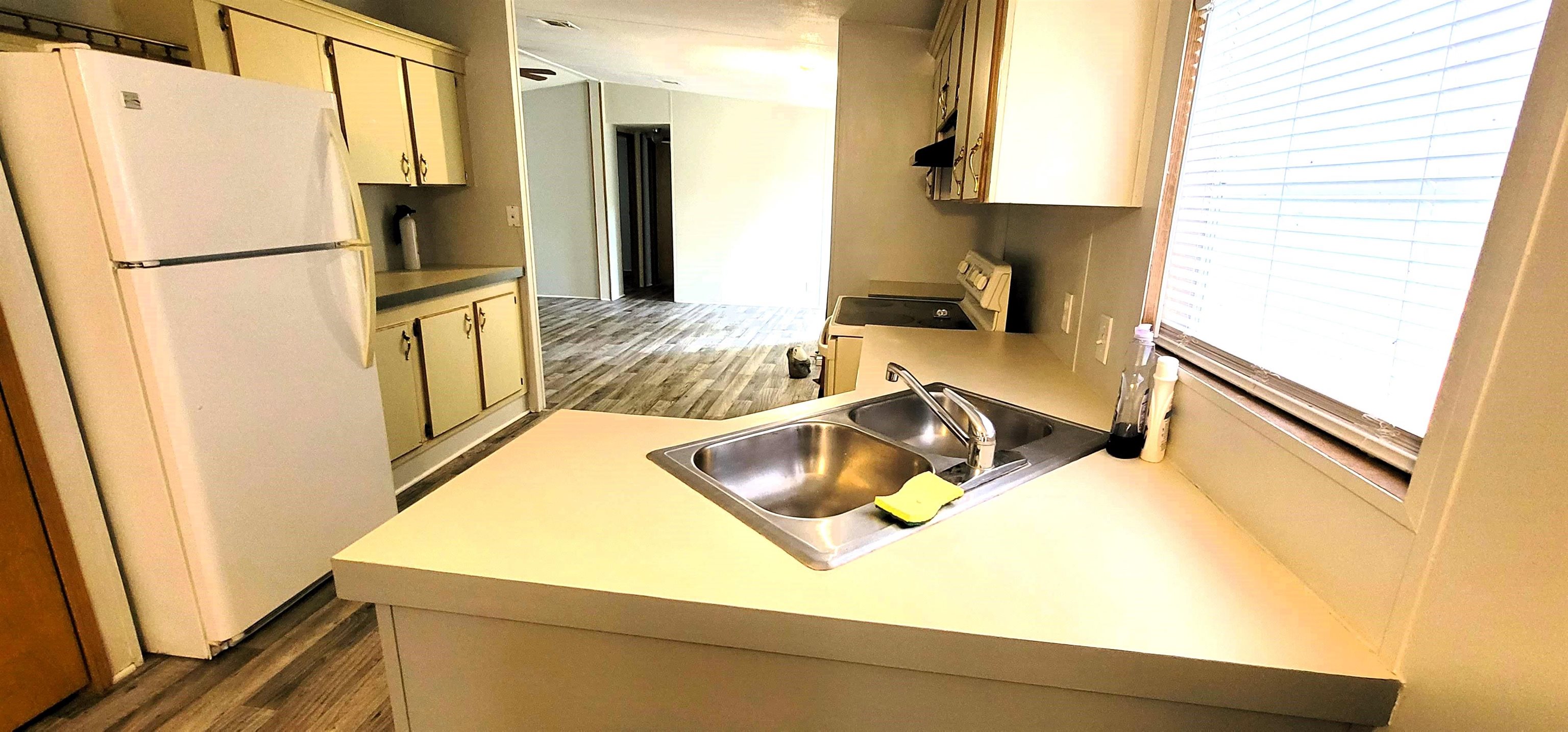 4920 Porter Road St. Augustine, FL 32095 - Photo 12 of 15 a kitchen with stainless steel appliances a refrigerator sink and stove