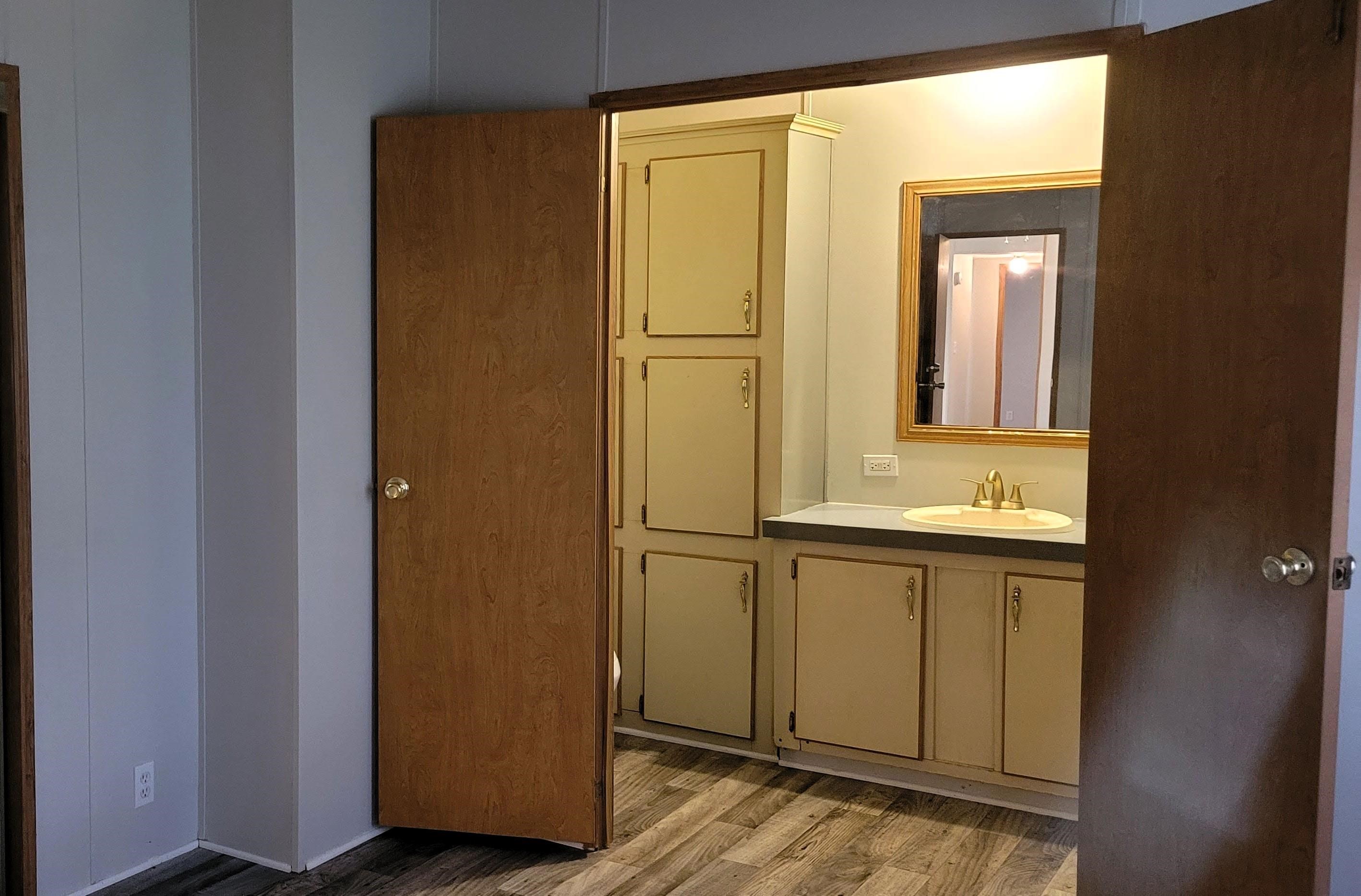 4920 Porter Road St. Augustine, FL 32095 - Photo 4 of 15 a view of a bathroom with a sink and mirror