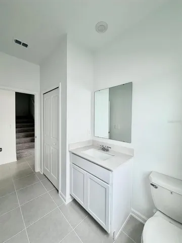 a bathroom with a sink toilet and vanity