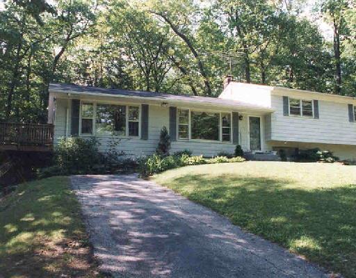 96 Aspen Ledges Road Ridgefield, CT 06877 - Photo 1 of 1 a front view of a house with a yard and trees
