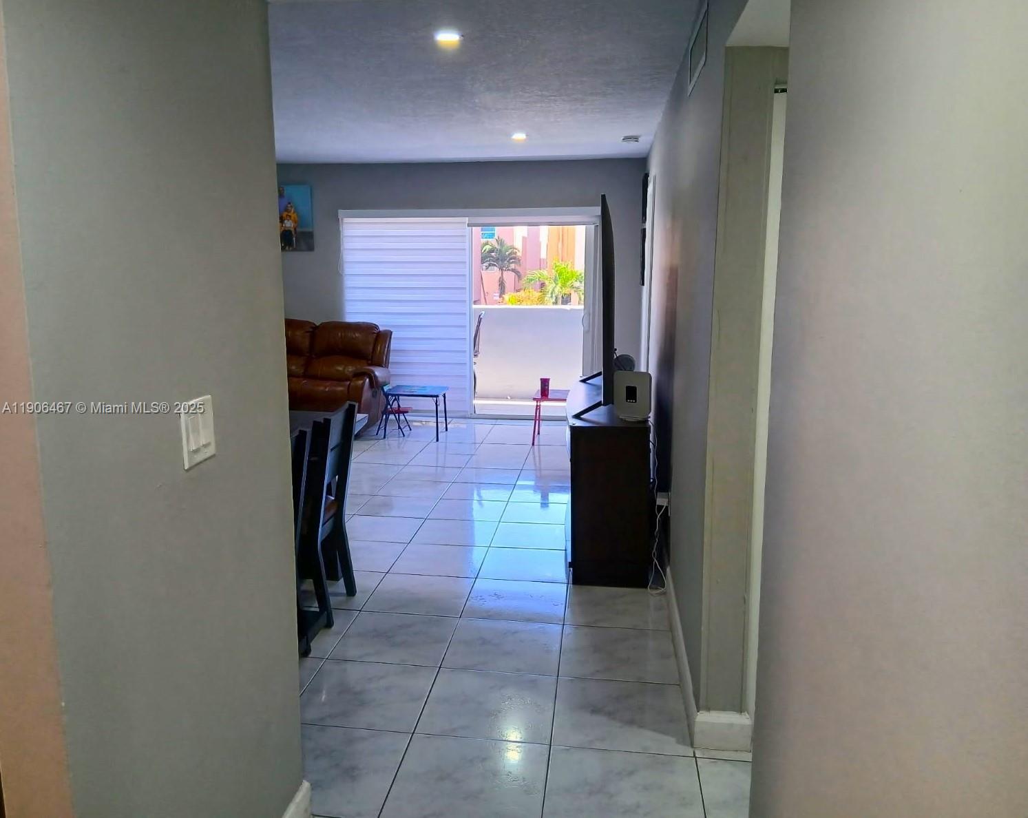 6070 West 19th Avenue, Unit 110 Hialeah, FL 33012 - Photo 7 of 9 a kitchen with a refrigerator and a table