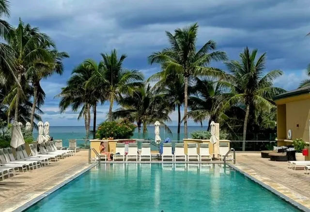 a view of a swimming pool with a table and chairs