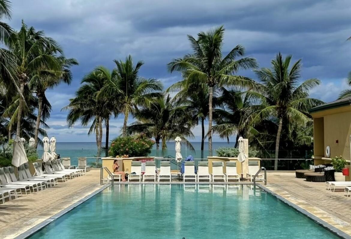 a view of a swimming pool with a table and chairs