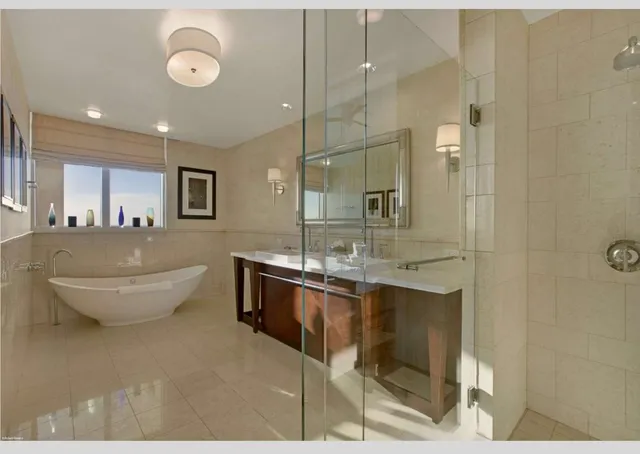a dining room with furniture a chandelier and wooden floor