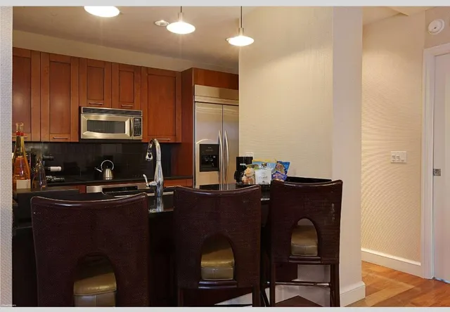 a kitchen with a refrigerator and a sink