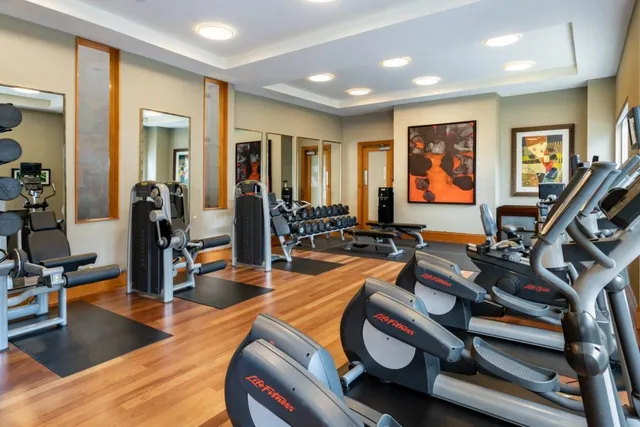 a white bath tub sitting under a blue and white umbrella