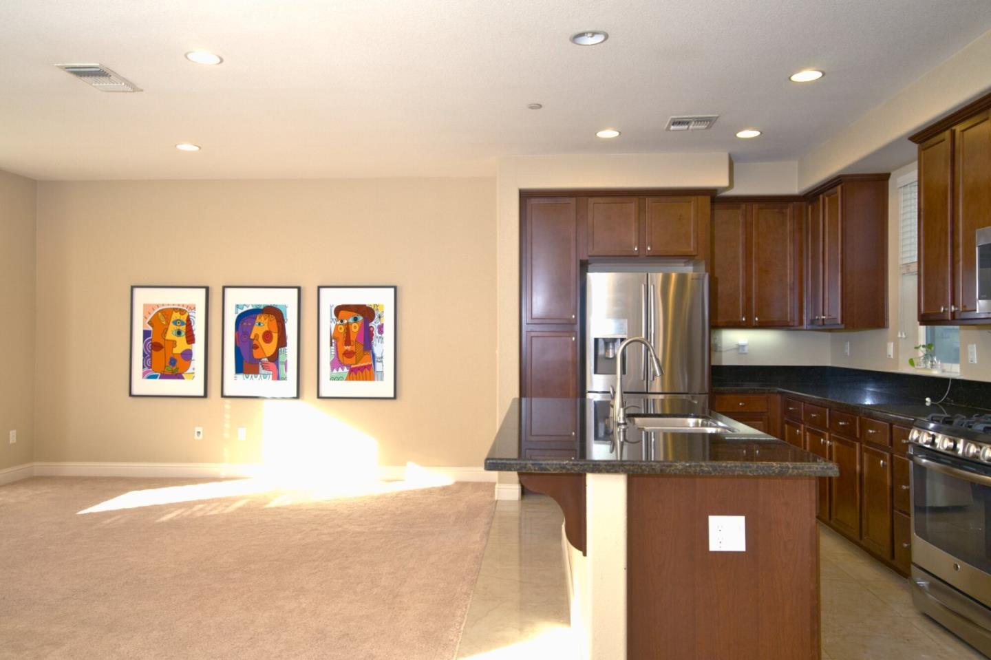 1579 Canal Street Milpitas, CA 95035 - Photo 14 of 36 a kitchen with stainless steel appliances granite countertop a refrigerator a stove top oven a sink with island and chairs