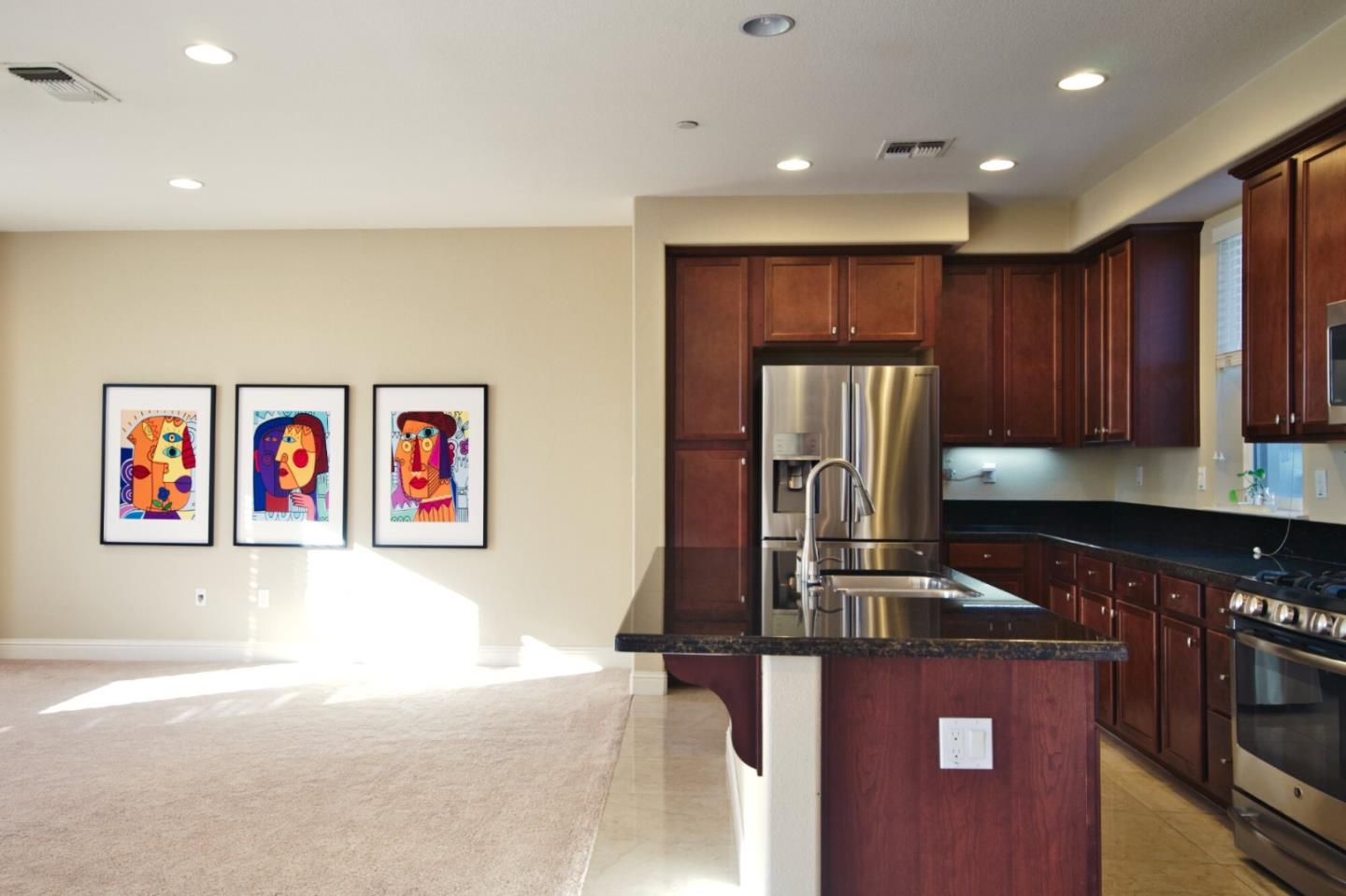 1579 Canal Street Milpitas, CA 95035 - Photo 17 of 36 a kitchen with kitchen island granite countertop a stove top oven a sink and a refrigerator