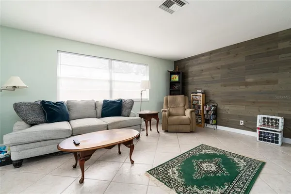 a living room with furniture a rug and a window