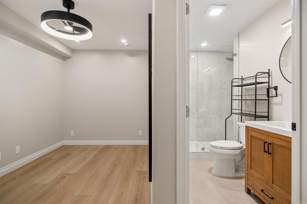 1622 Swallowtail Road Encinitas, CA 92024 - Photo 15 of 20 a bathroom with a toilet a sink and a mirror