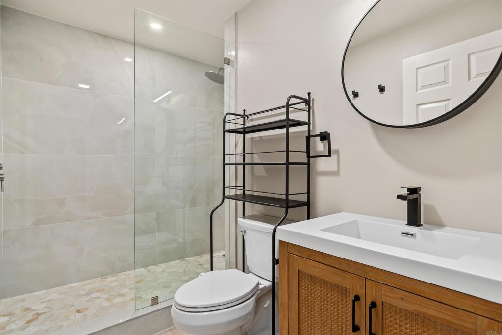 1622 Swallowtail Road Encinitas, CA 92024 - Photo 16 of 20 a bathroom with a sink a toilet and shower