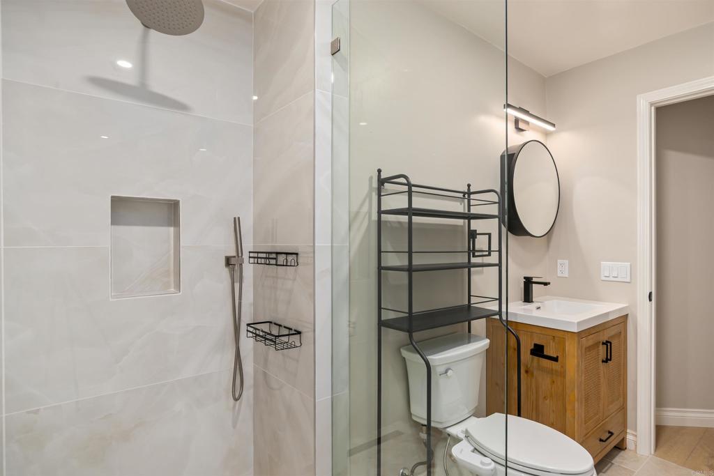 1622 Swallowtail Road Encinitas, CA 92024 - Photo 17 of 20 a bathroom with a toilet sink and shower