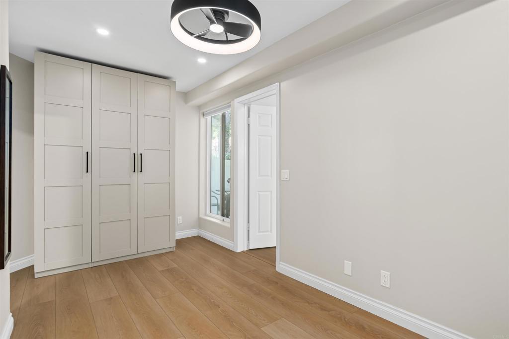 1622 Swallowtail Road Encinitas, CA 92024 - Photo 10 of 20 an empty room with wooden floor and chandelier