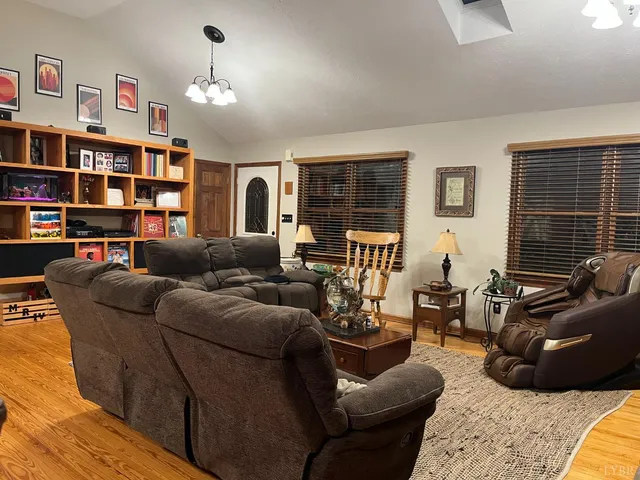 a living room with furniture and a book shelf
