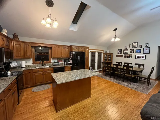 a large kitchen with stainless steel appliances kitchen island granite countertop a large island in the center