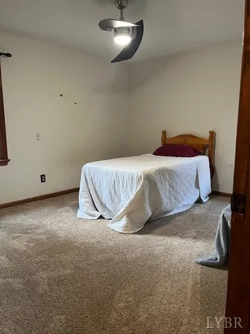 a spacious bedroom with a bed and a night stand