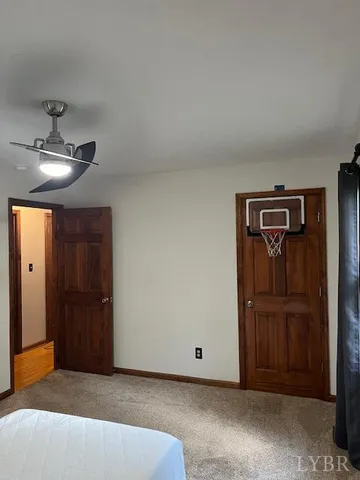 a view of an empty room with closet and workspace